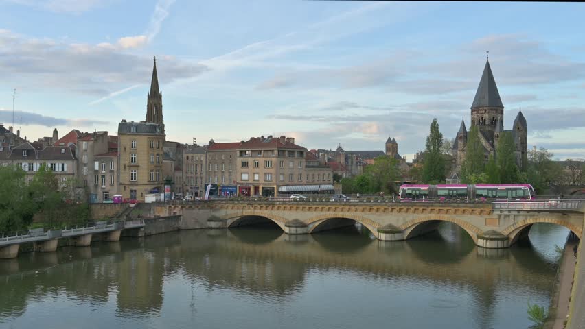 Cityscape of Metz with the river Moselle and the so called Temple Neuf Church at sunset - France