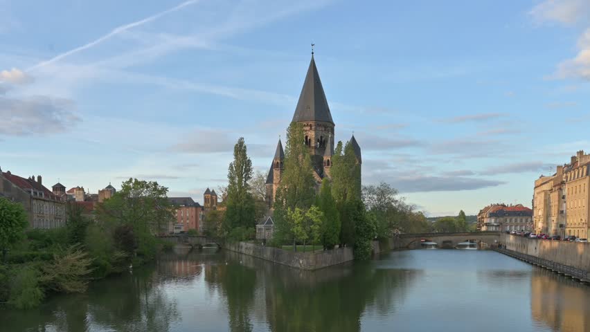 Cityscape of Metz with the river Moselle and the so called Temple Neuf Church at sunset - France