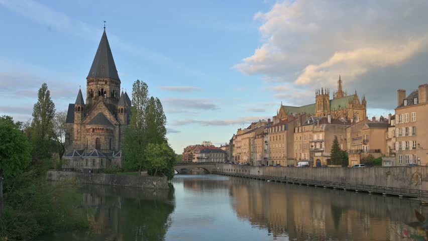 Cityscape of Metz with the river Moselle and the so called Temple Neuf Church at sunset - France
