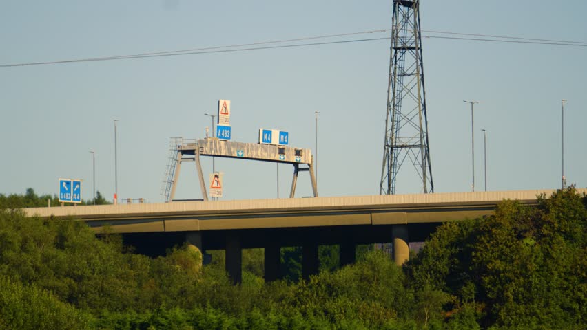 M4 Motorway Overpass Bridge at Junction 42 Fabian Way with Electricity Pylons with Trees Below.