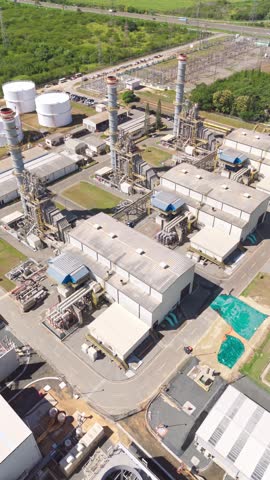 Large industrial fans on cooling tower at Energa 4 power generation plant in San Pedro de Macoris, Dominican Republic. Aerial dorne orbiting, vertical format