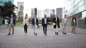 A diverse group of confident business professionals walking together, showcasing their teamwork and unity in a corporate setting while dressed in sophisticated business attire. - Powered by Shutterstock - Get 15% off with code: PIKWIZARD15
