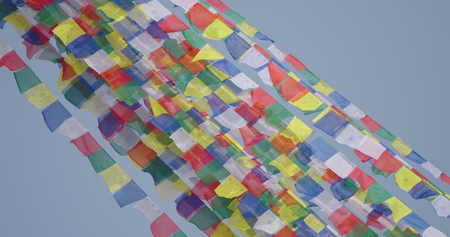 Boudhanath Stupa, Kathmandu, Nepal. Colorful Buddhist prayer flags shine under the sun and flow freely in the wind, symbolizing spiritual peace, calm vibration, and sacred cultural heritage