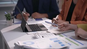 Professional businesswomen analyzing financial data, collaborating during strategic team meeting in modern office setting, sharing project insights - Powered by Shutterstock - Get 15% off with code: PIKWIZARD15