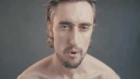 Funny Look: Close-Up Video of Male Subject Displaying Nuanced Facial Expressions and Emotions While Making Eye Contact with Camera - Powered by Shutterstock - Get 15% off with code: PIKWIZARD15