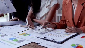 Female professionals collaborating during financial analysis, reviewing charts and calculating data at modern office workspace - Powered by Shutterstock - Get 15% off with code: PIKWIZARD15