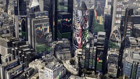 aerial view of the london city financial skyline from a helicopter with trading data mapped onto the buildings - Powered by Shutterstock - Get 15% off with code: PIKWIZARD15
