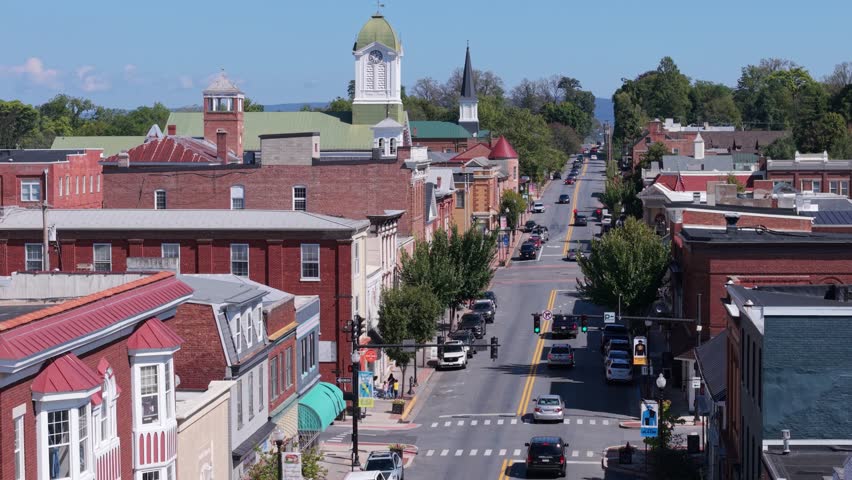 Explore the vibrant main street of Charles Town, West Virginia, showcasing the historic courthouse and charming community on a sunny autumn day.