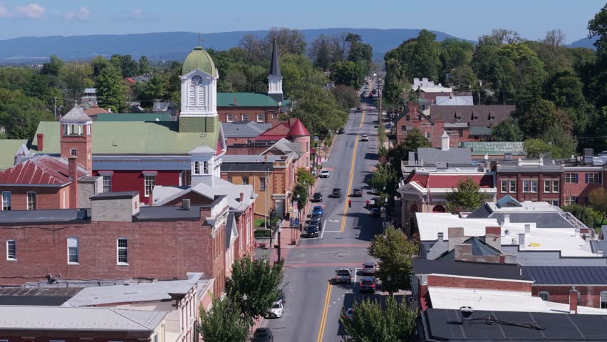 Experience a beautiful aerial view of Charles Town, West Virginia on a sunny autumn day, showcasing the courthouse and vibrant main street community.