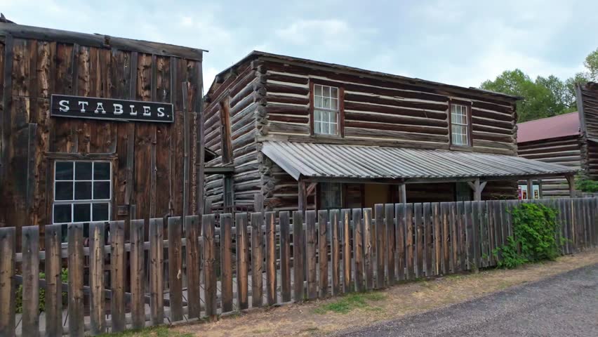 A collection of old, vintage wooden buildings captured at the Nevada City Living History Museum in Montana on summer day