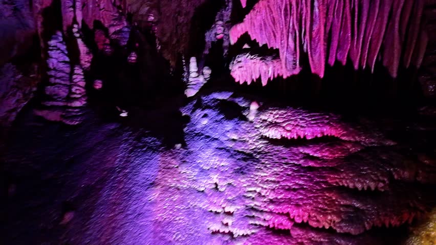 A scenic and illuminated view of the caverns inside Lewis and Clark Caverns State Park is captured, highlighting the stunning geological formations and the unique lighting that enhances their beauty