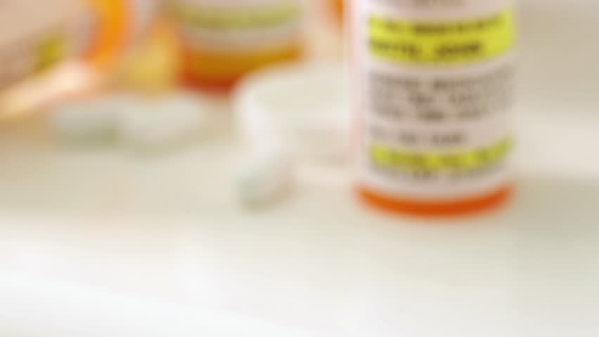 Slow Dolly Camera Movement Generic Medication Prescription Medicine Bottle and Pills Resting on a Bathroom Countertop.