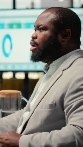 Vertical Video Recruiting team and an applicant engaging in CV evaluation in a business office, discussion about career experience and aspirations for growth. Interview process for professional