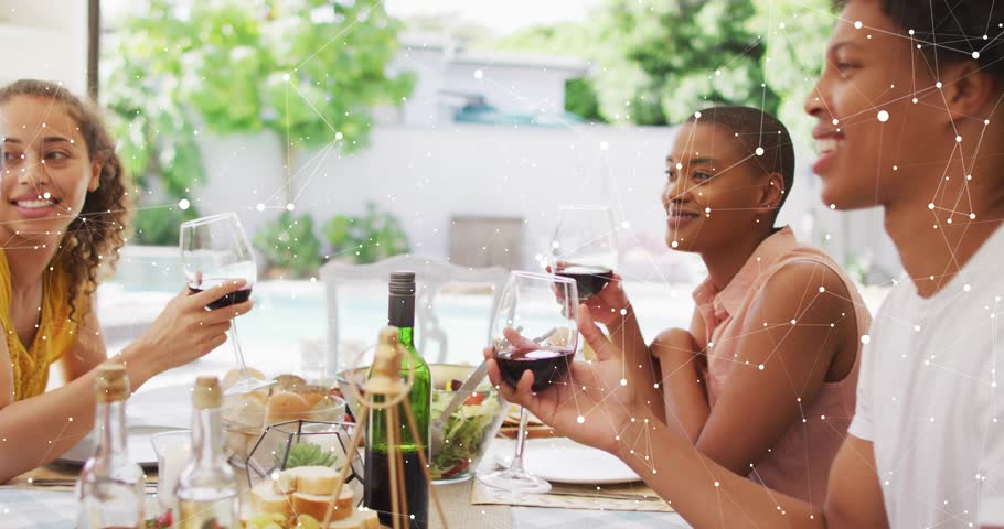 Group of friends raising wine glasses on sunlit patio, igniting tech HUD tracking glass movements. Friends, celebration, technology, digital, social, outdoor, vibrant