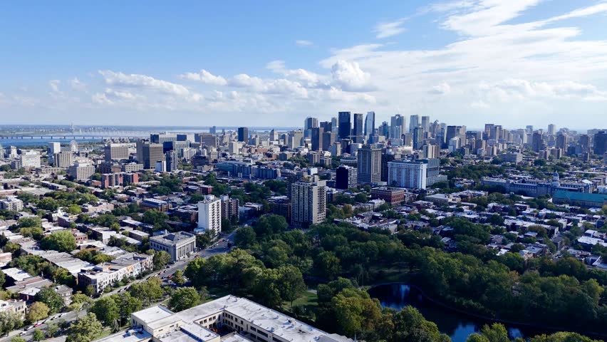 Aerial view of Montreal Parc La Fontaine with greenery and urban grid in the background. g.