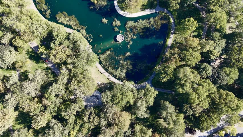 Aerial view of Montreal Parc La Fontaine with greenery and urban grid in the background. g.