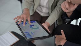Business colleagues analyze financial charts and data on a tablet during a meeting - Powered by Shutterstock - Get 15% off with code: PIKWIZARD15