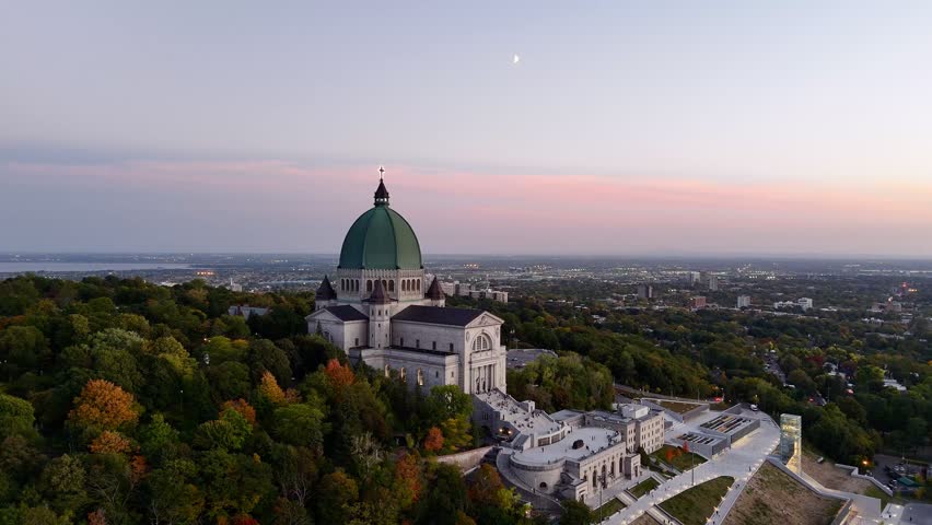 Sunset view of Saint Joseph Oratory in Montreal, Canada, with city panorama and sky. g.