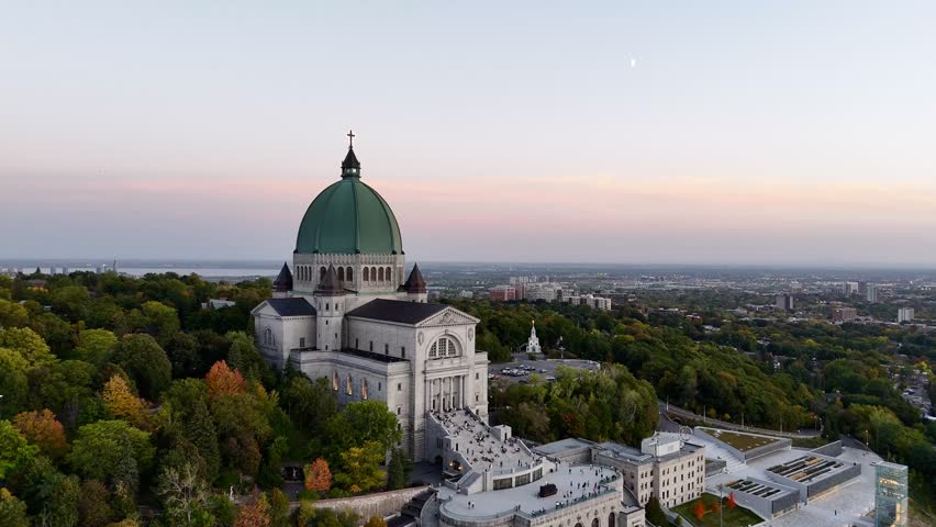 Sunset view of Saint Joseph Oratory in Montreal, Canada, with city panorama and sky. g.