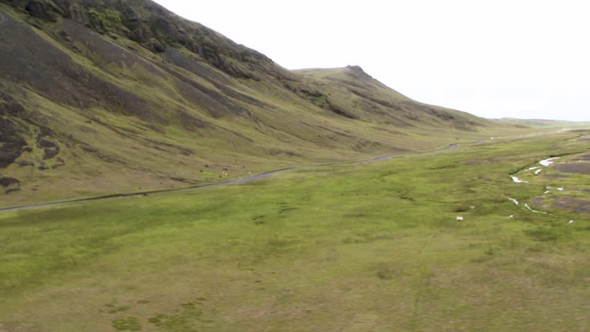 Scenic Icelandic landscape with lush green hills and serene atmosphere