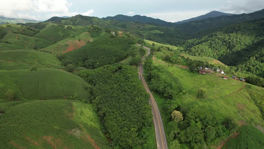 Aerial view of the greenery hills and mountain road by drone