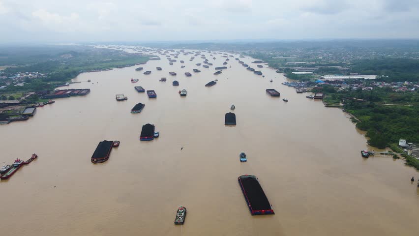 An aerial view of the congested coal barge traffic on the Mahakam River in Samarinda, Borneo. Hundreds of barges fill the waterway, a vital artery for Indonesia