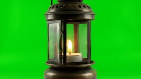 Beautiful vintage lantern with a glowing candle flame dynamically flickering on a vibrant green screen for easy chroma key compositing - Powered by Shutterstock - Get 15% off with code: PIKWIZARD15