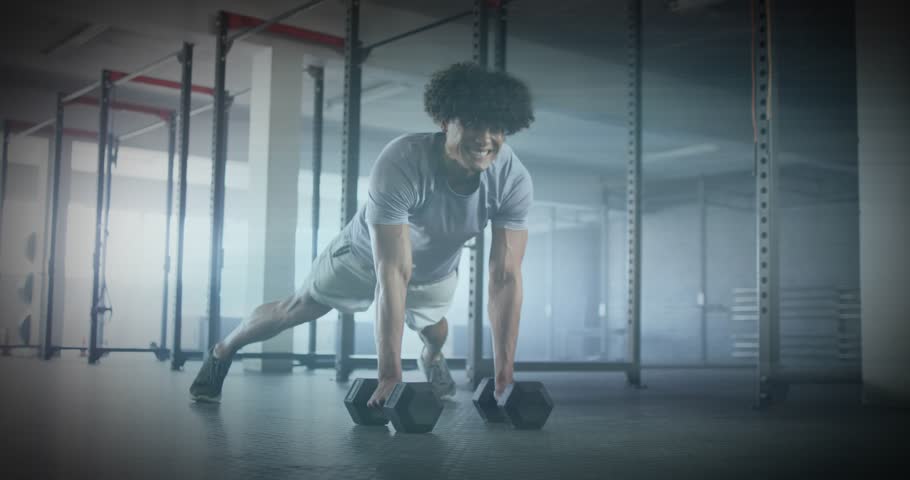 Man gripping black dumbbells in plank, initiating renegade row improving fitness with green overlay. Strength, training, workout, fitness, endurance, athleticism, relaxation