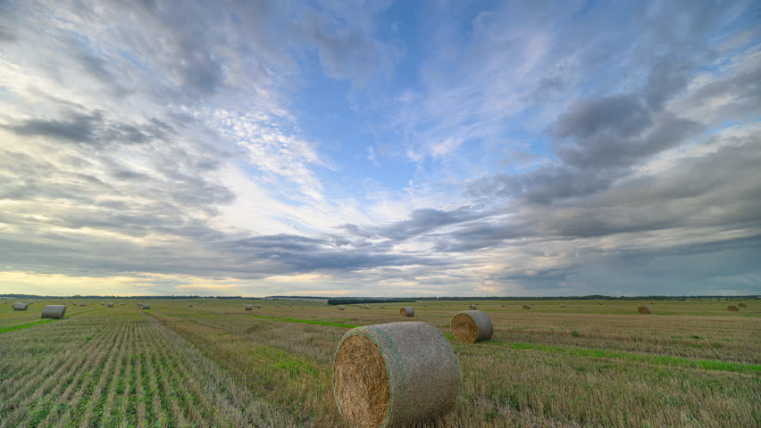 A beautiful scenic landscape showcasing bales set against a stunning cloudy sky backdrop