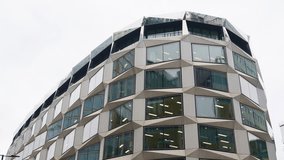 Close-up of a unique office building facade with angled, geometric window frames in London, England near the financial center - Powered by Shutterstock - Get 15% off with code: PIKWIZARD15