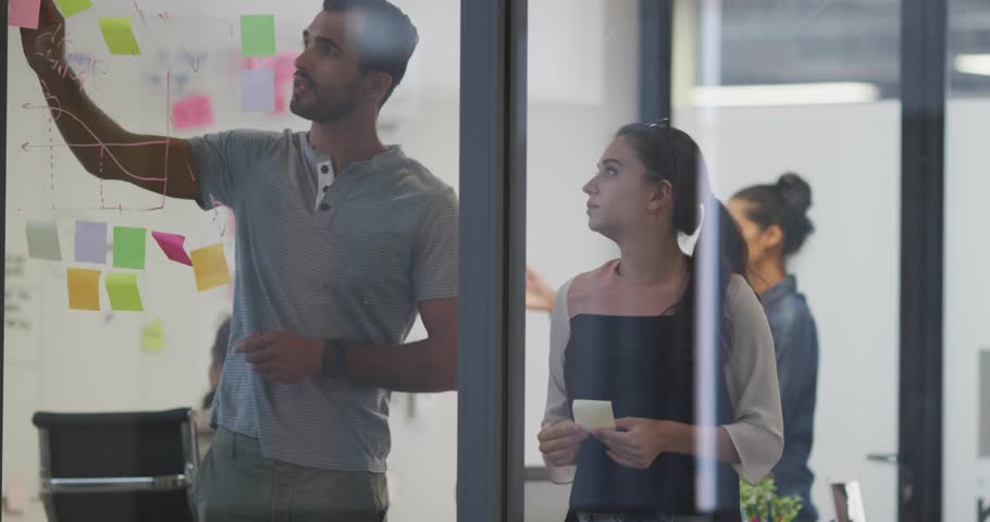 Picking up marker developer sketching glass in tech meeting manager organizing notes pointing code. Collaboration, brainstorming, innovation, digital, modern, teamwork, whiteboard