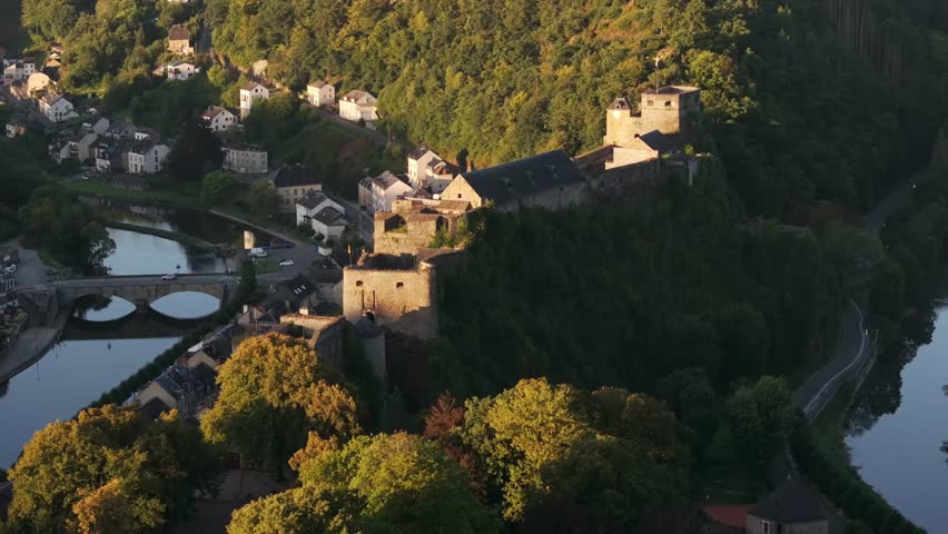 Aerial pan of Bouillon Chateau and village in the Ardennes at sunset