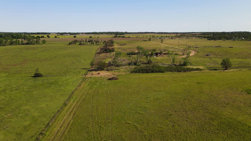 Aerial view approaching a destoyed house, Twister aftermath in sunny Kansas, USA