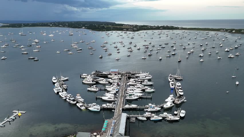 Aerial view of boats docked at New Harbor, with their white hulls contrasting with the dark blue water, New Shoreham, Rhode Island, United States.