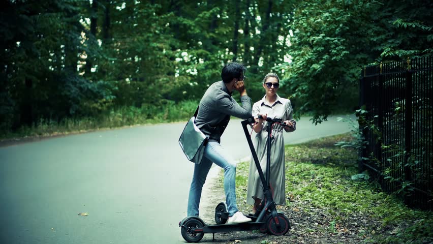 Eco Driving Electric Scooter. Relax On Kick Scooter. Sharing Ecology Transport. Woman Riding On Rent E-scooter. Urban Style Green Energy City Transport. Ecological Transportation Mobility In City Ride
