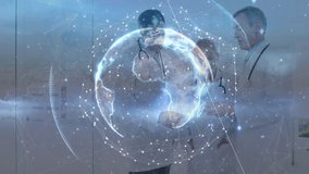 Doctors evaluating tablet shaking hands and activating digital globe overlay for global healthcare. Medical, collaboration, technology, connectivity, innovation, professional, team - Powered by Shutterstock - Get 15% off with code: PIKWIZARD15