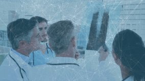 Doctor holding chest X-ray film against window, colleagues pointing at lung, discussing diagnosis. Medical, professional, collaboration, radiology, healthcare, diagnostic, team - Powered by Shutterstock - Get 15% off with code: PIKWIZARD15