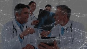 Female doctors bringing X-ray film as medical team reviewing network graphics for diagnosis. Medical, collaboration, technology, healthcare, analysis, professional, digital - Powered by Shutterstock - Get 15% off with code: PIKWIZARD15