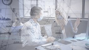 Masked coworkers collaborating on data analytics, gesturing at monitor, tracing animated graphs. Collaboration, analytics, professional, teamwork, technology, urban, innovation - Powered by Shutterstock - Get 15% off with code: PIKWIZARD15