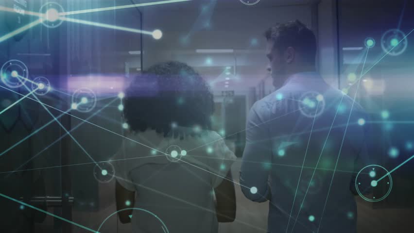 Network analyst pointing data center racks, overlay trailing IT pro tapping tablet, fading at exit. Technology, data, digital, cybersecurity, innovation, connectivity, corporate - Powered by Shutterstock - Get 15% off with code: PIKWIZARD15