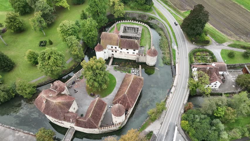 Aerial view of Hallwyl Castle surrounded by a moat with lush green trees, Seengen, Aargau, Switzerland.