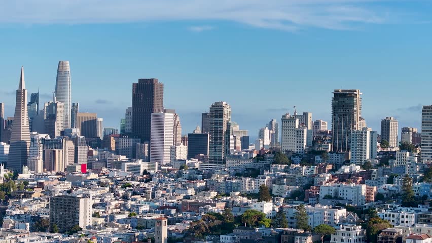 Aerial view of San Francisco showcasing the Transamerica Pyramid and Salesforce Tower against a clear blue sky, San Francisco, California, United States.