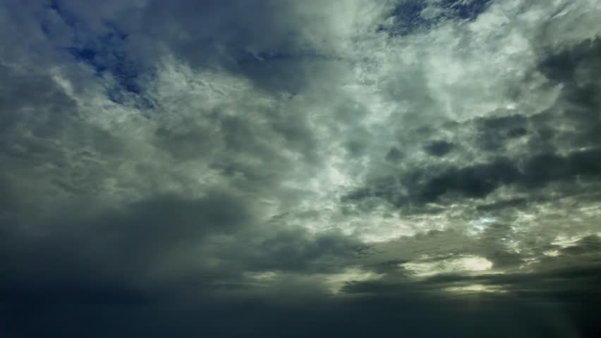 an aerial view of a sunset from the sky, taken from an airplane cockpit , flying under a darkening layer of ethereal clouds