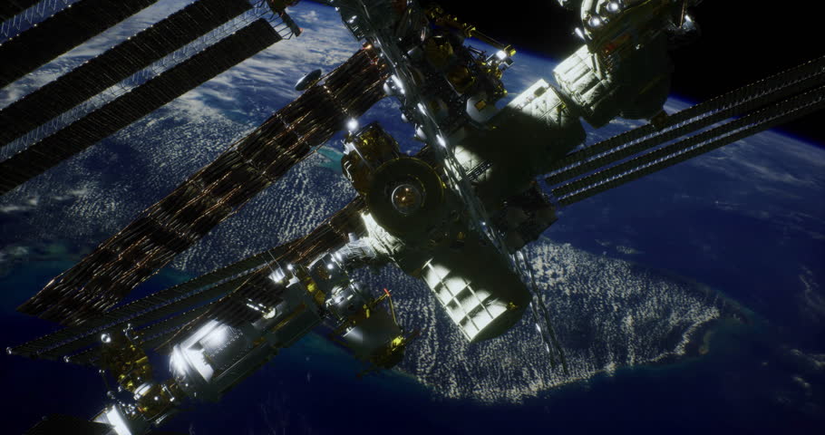 The International Space Station floats above Earth, illuminated by city lights. This stunning view captures the intricate structure of the station against the dark backdrop of space.