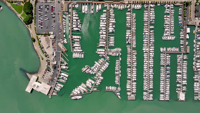 Aerial view of boats docked in rows, creating a stunning display of maritime activity against the backdrop of the sea, Sausalito, California, United States.