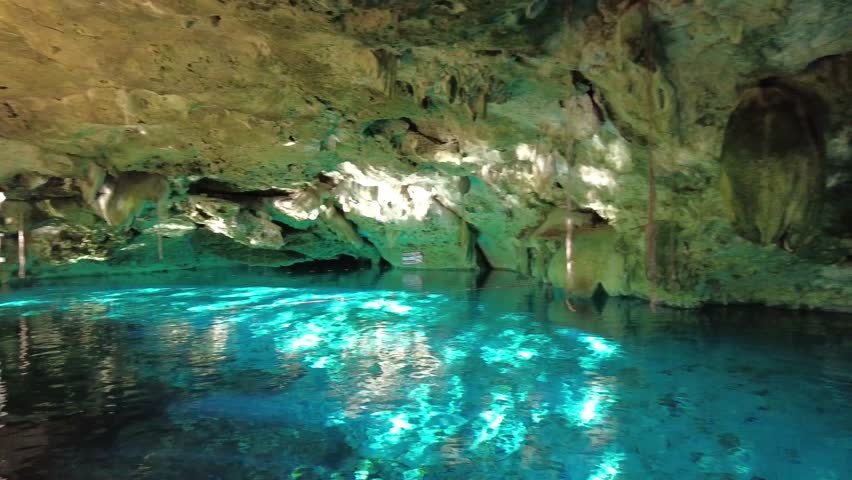 Turquoise reflections in a cenote cave, Mexico