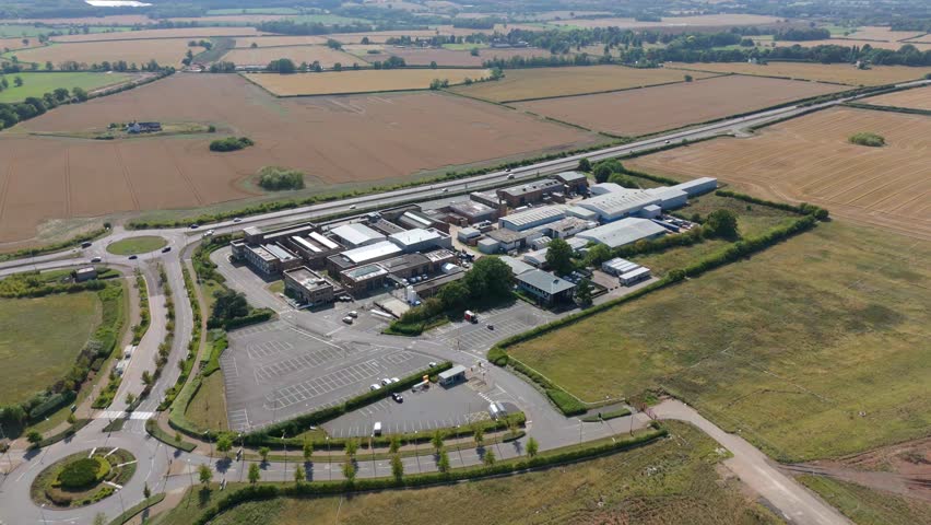 Aerial drone view of motor industry research innovation centre, warehouse business park in England UK