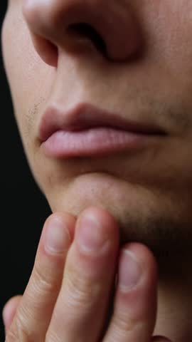 Macro close-up of young man sparse facial stubble, concept of imperfection, insecurity, masculinity. Vertical Video