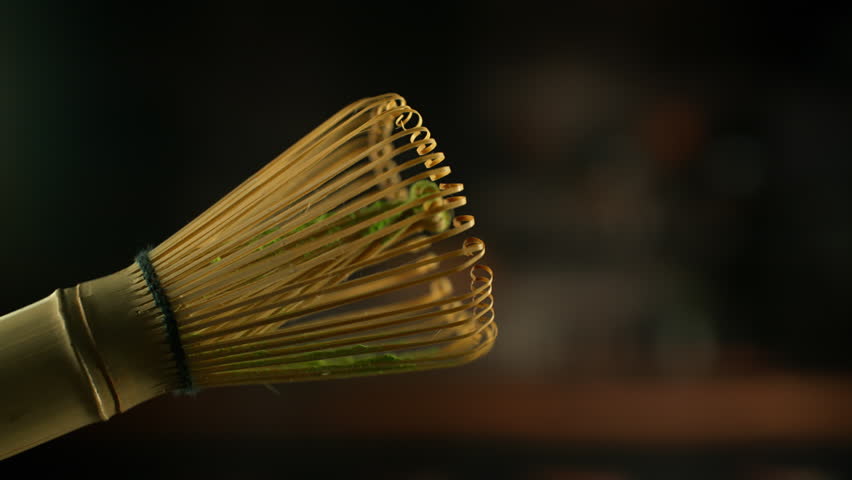 Super Slow Motion Shot of Flying Matcha Powder From Chasen Whisk with Copy Space at 1000fps.