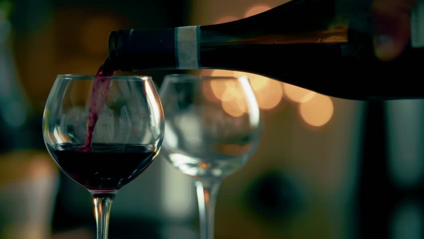 Pouring Red Wine Into Glass At Dinner Party. Alcohol Beverage Service. Romantic Evening Drink Fine Dining Experience. Celebrating Special Occasion Wine Tasting Event. Luxurious Social Gathering Dinner